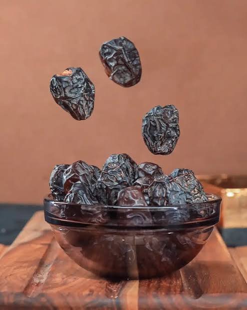 Close view of Ajwa Madinah dates in a woven bowl
